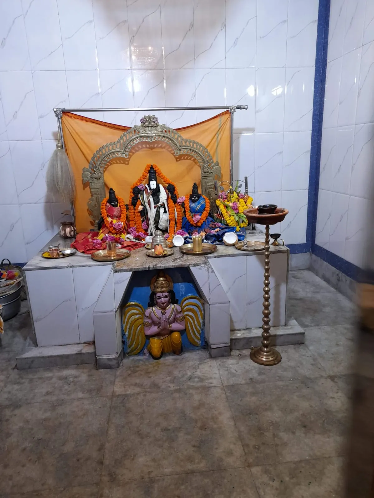 Inner shrine at Sri Venkateswara Swamy Temple, with the principal deities and a Garuda figure below the altar
