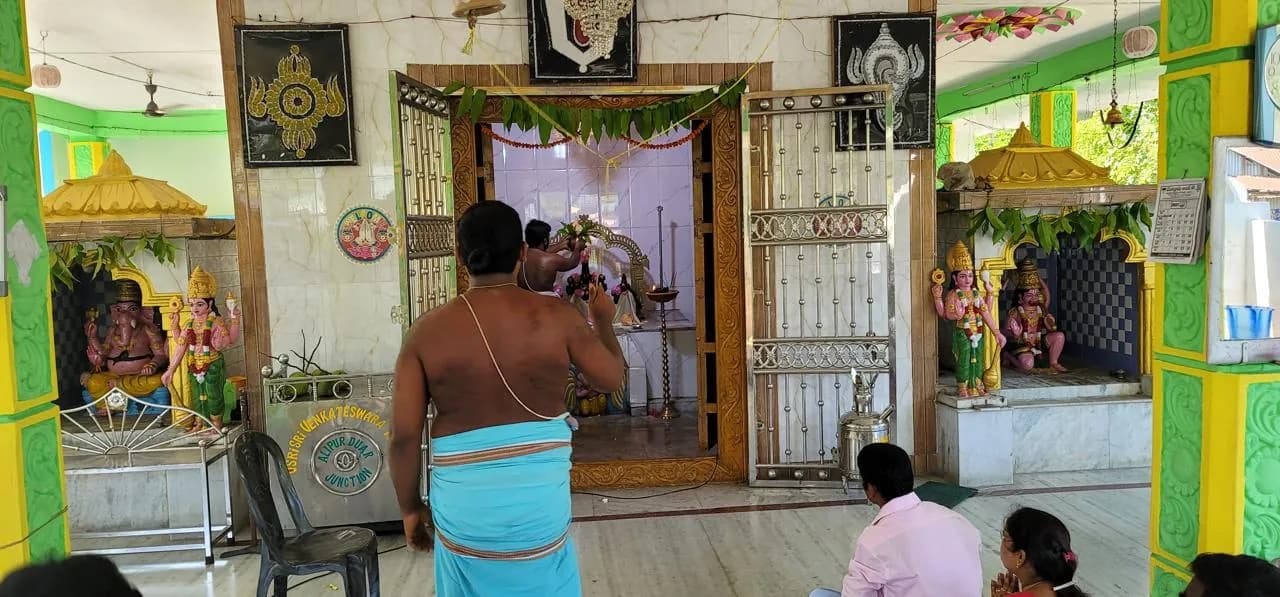 Interior of the prayer hall at Sri Venkateswara Swamy Temple, Alipurduar, looking toward the sanctum and side shrines